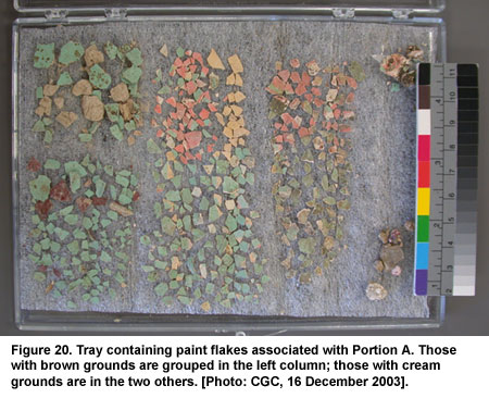 Figure 20. Tray containing paint flakes associated with Portion A. Those with brown grounds are grouped in the left column; those with cream grounds are in the two others. [Photo: CGC, 16 December 2003].